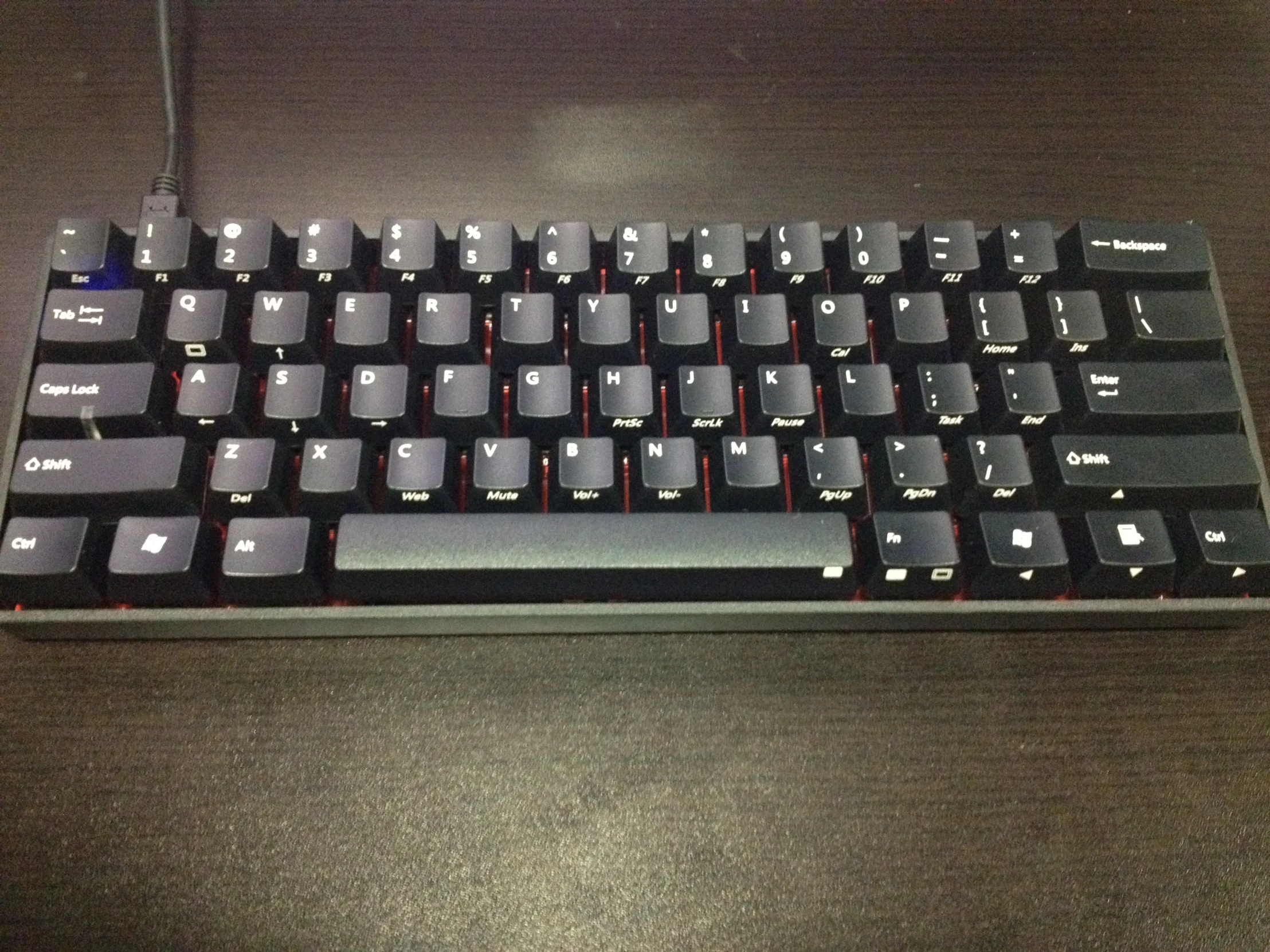 the large computer keyboard has an extra red / black tab