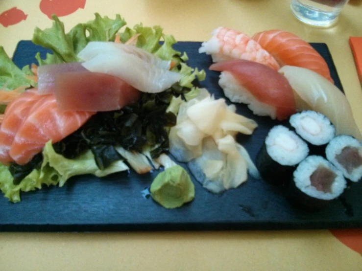 a plate with sushi and cucumber on it