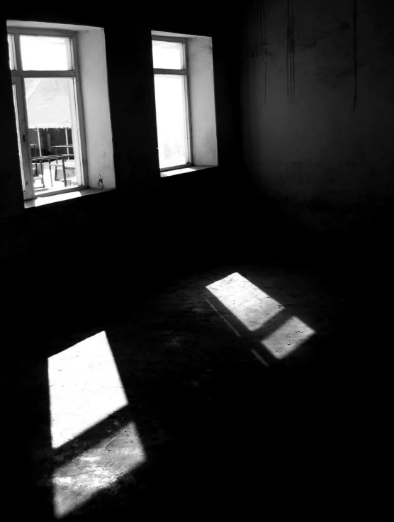 empty room with three windows and chair on the floor