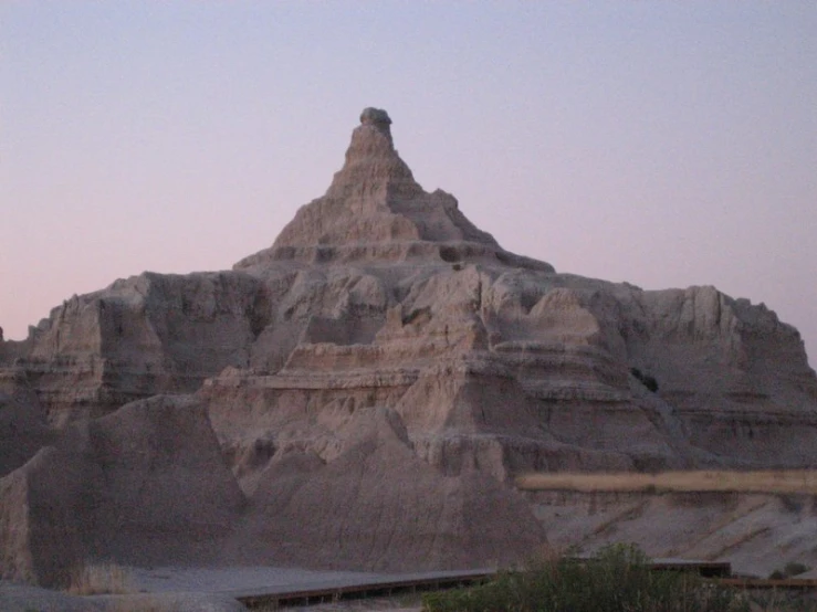 a small desert landscape with a large mountain