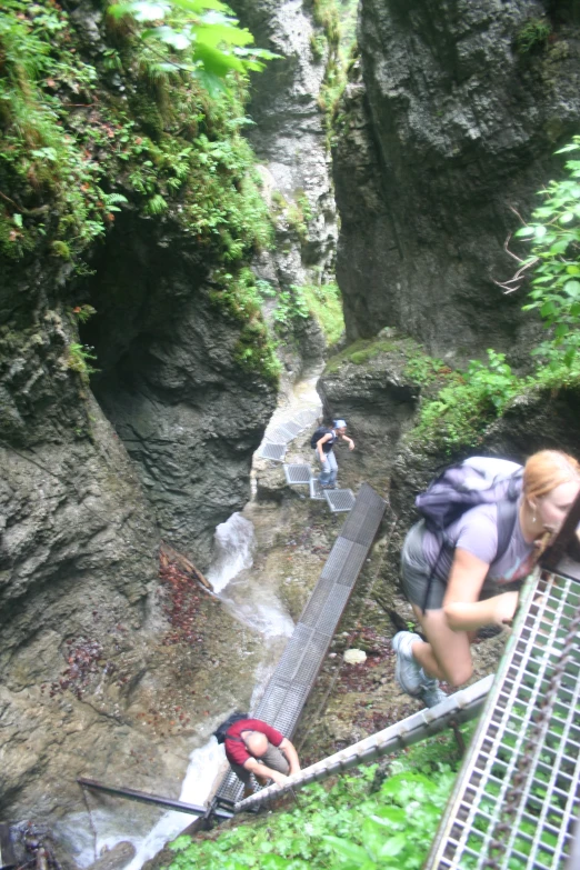 a girl with her head down on the ledge of a bridge