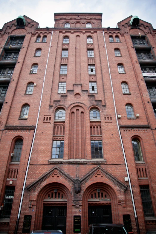 a tall red brick building with doors on both sides