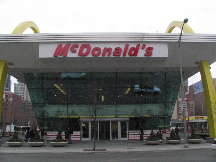 a mcdonalds store with two men standing outside it