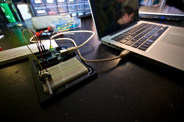 an electronic circuit is being hooked up to a laptop computer