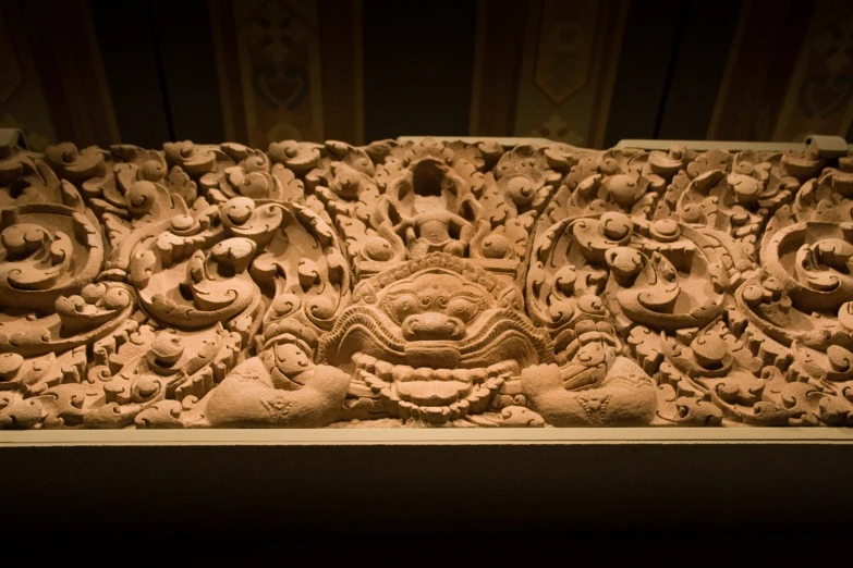 a close up of a carved stone face on display