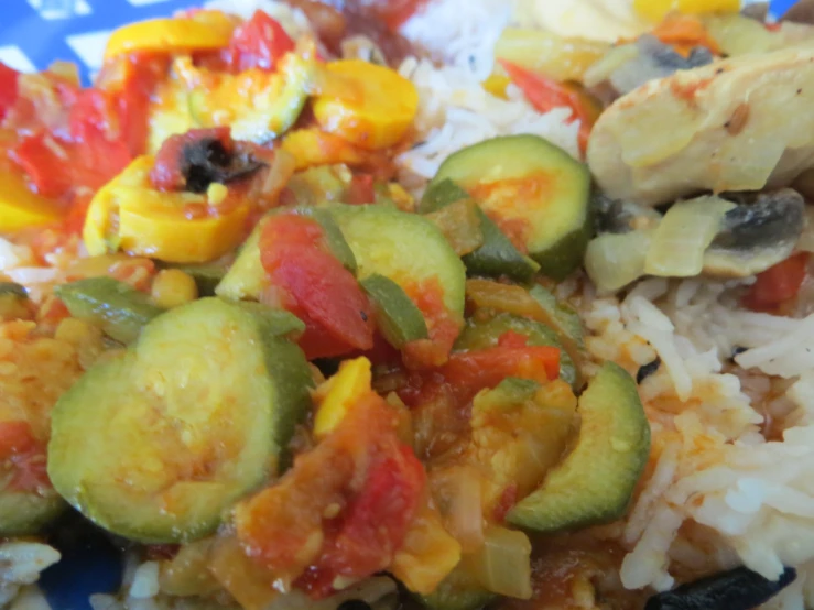 some cooked vegetables are in a yellow sauce over rice