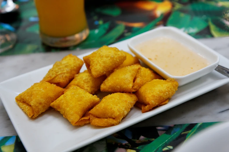 deep fried fish sticks and dipping sauce on a plate
