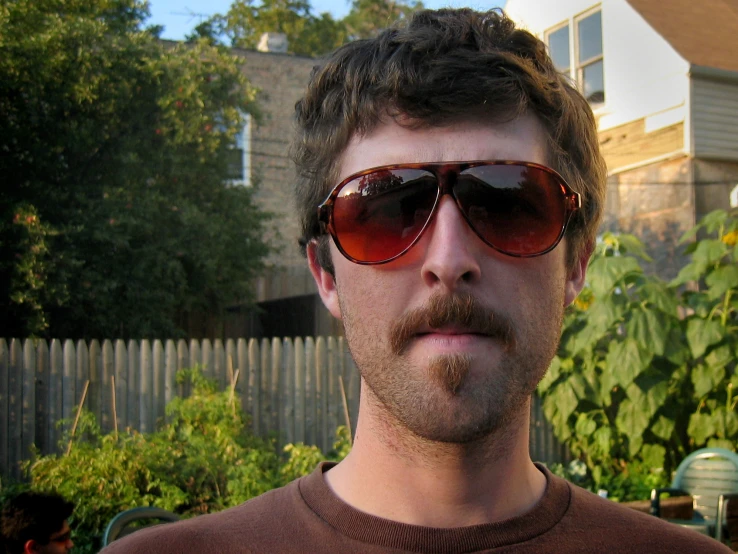 a man in sunglasses, mustache and mustache piercing