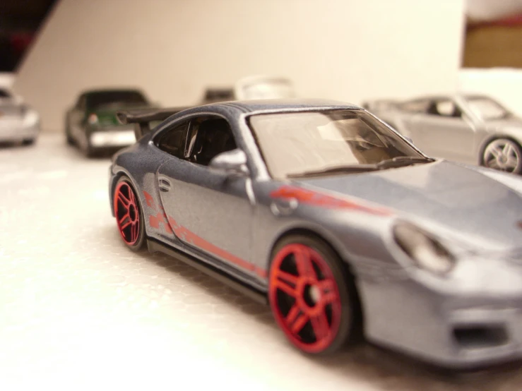 three models of cars in a display on a table