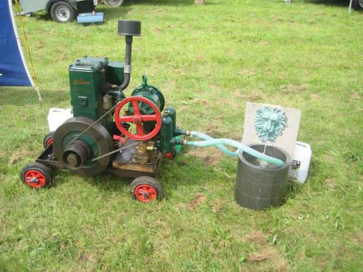 a tractor on wheels and a small bucket on the ground