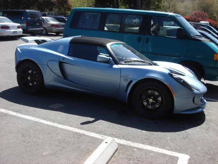 a small sports car sits in a parking lot