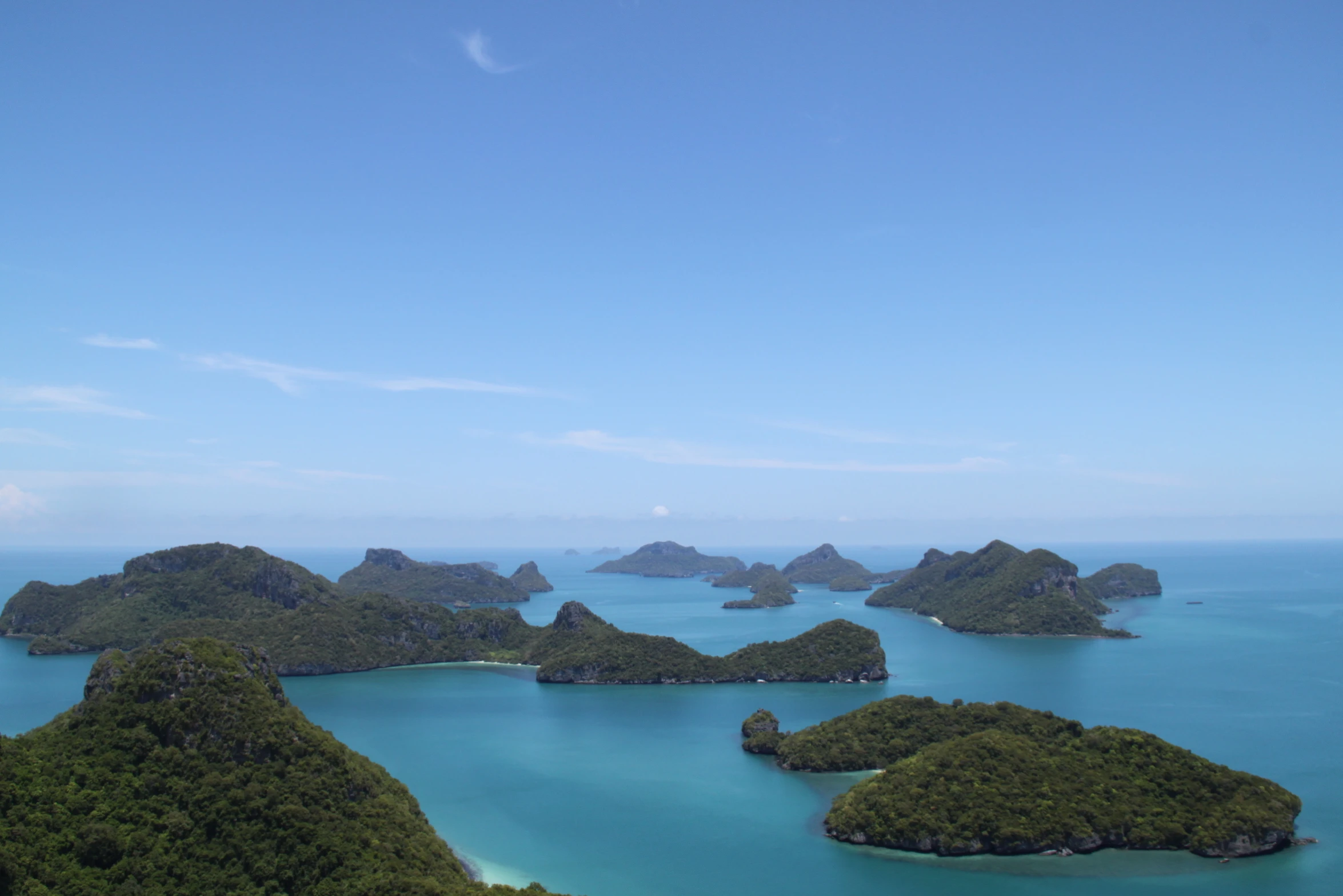 several small island surrounded by turquoise water