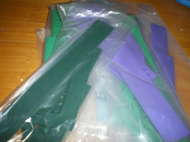 plastic green purple and blue are laying on a table