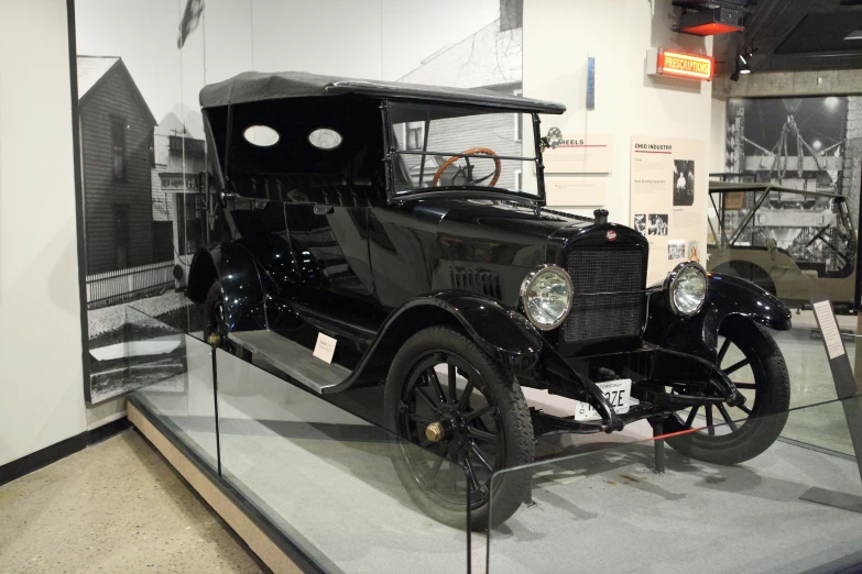 the old model car is on display in the museum