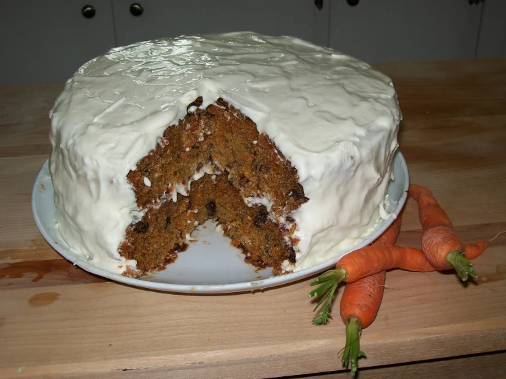 a carrot cake with a slice missing from it