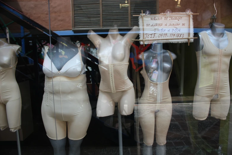 several mannequins are displayed in a window