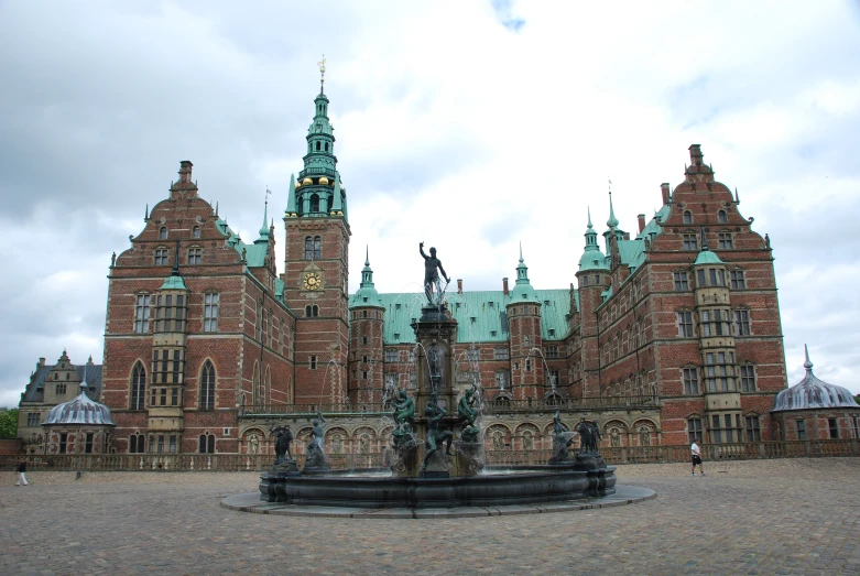 a large building with two towers and clocks on top