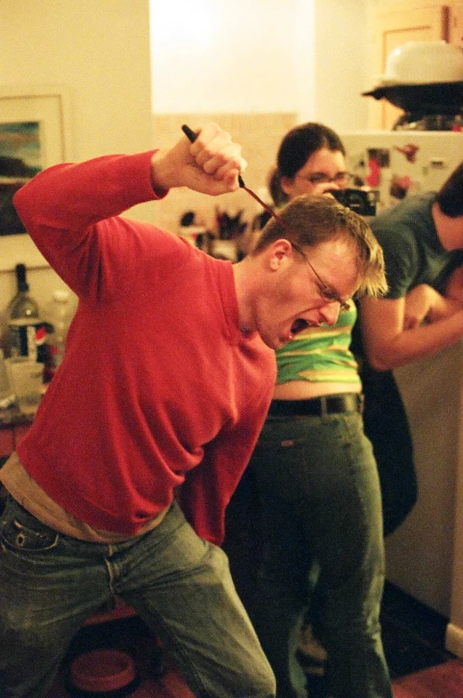 a man getting ready to blow out some chocolate icing