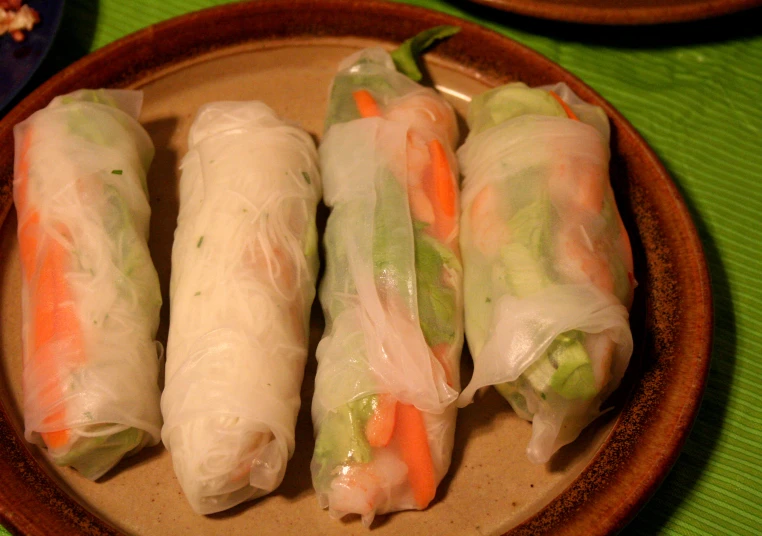 three pieces of vegetable spring rolls on a plate
