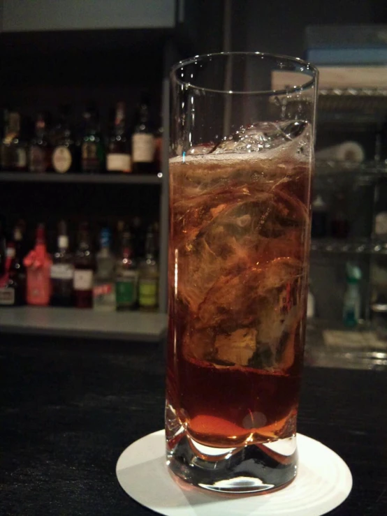 a glass filled with liquid sitting on top of a table