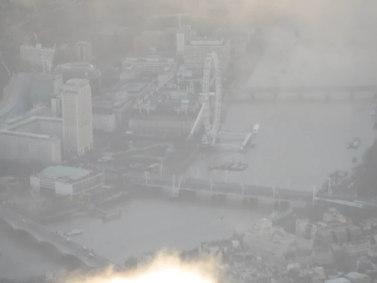 an aerial po of a cloudy city and an industrial area