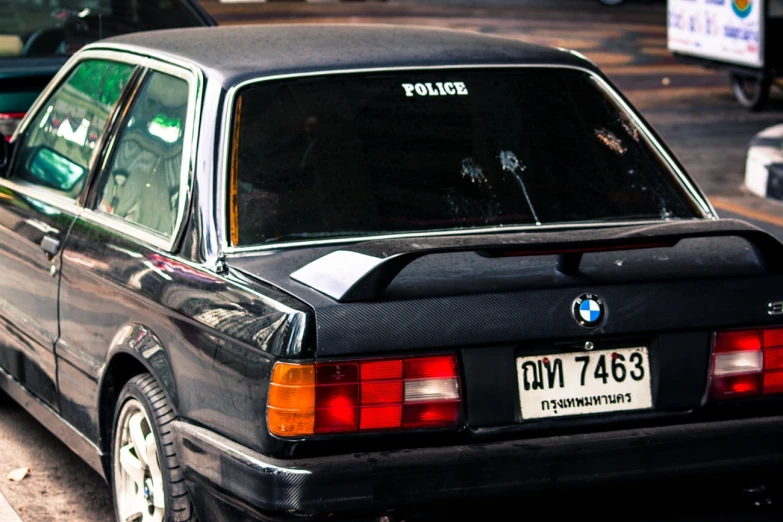 a bmw is parked in front of an intersection