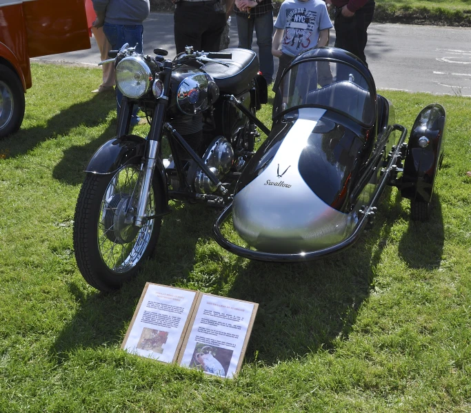 two motorcycles are parked near one another on the grass