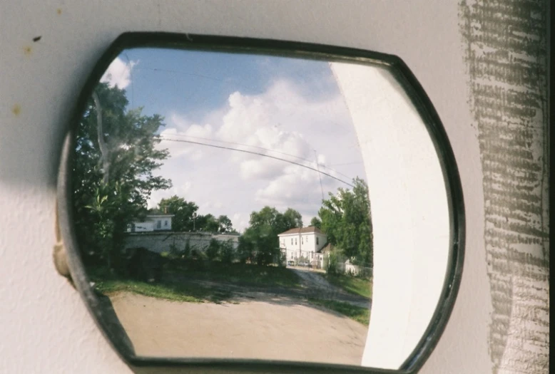 this is an image of a side view mirror showing a house