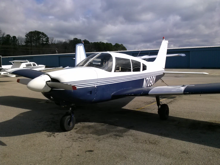 a small plane sitting on top of an airport tarmac