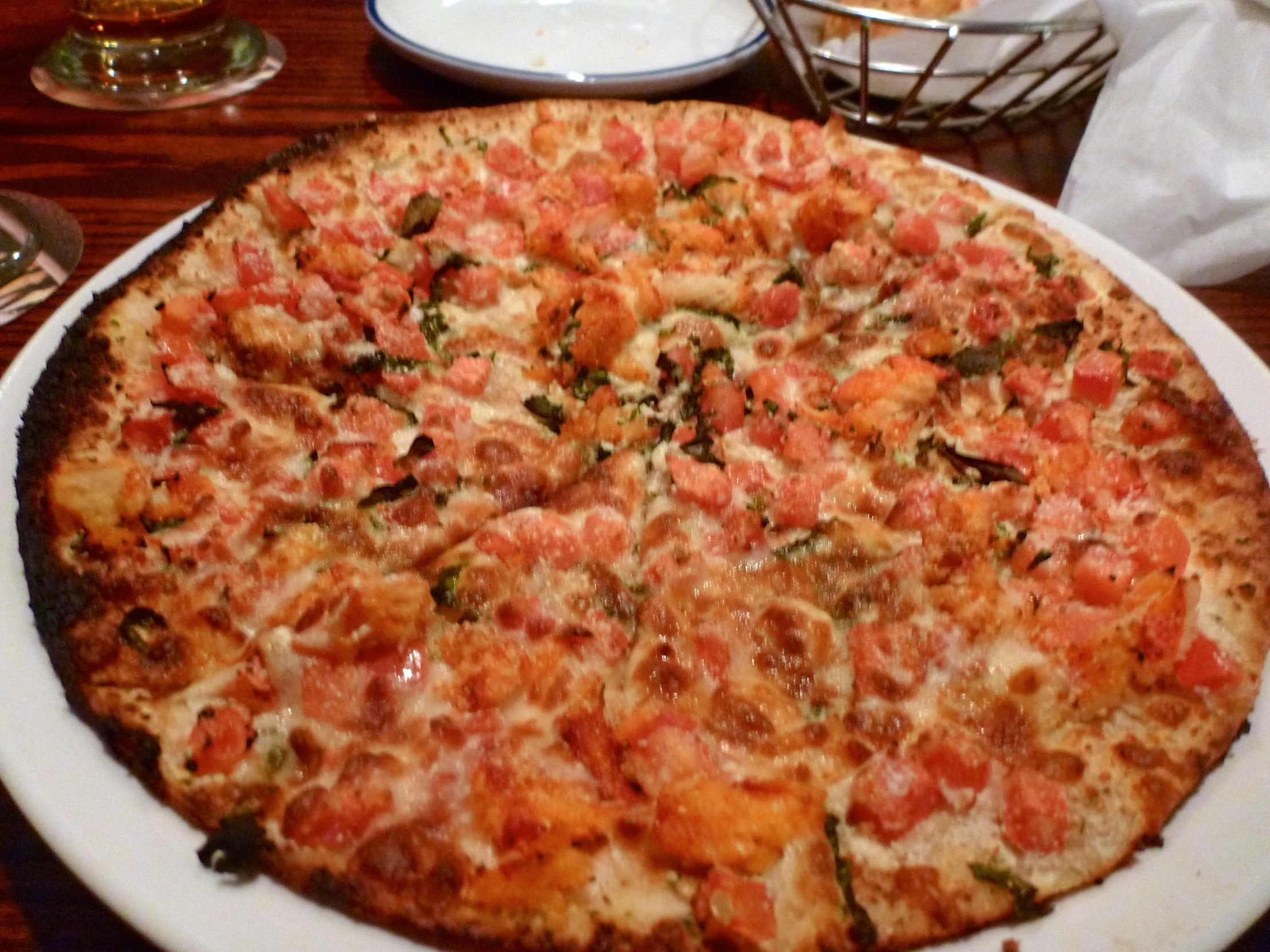 a pizza with many toppings is shown on the table