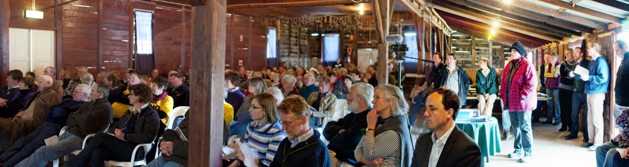 an audience looks on as some of them have turned to listen