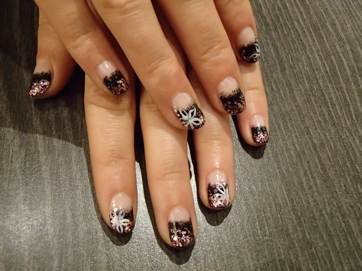woman's nails with nail art and flowers