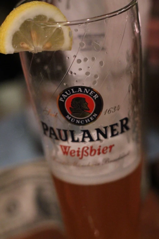 a close up of a glass with a lemon wedge