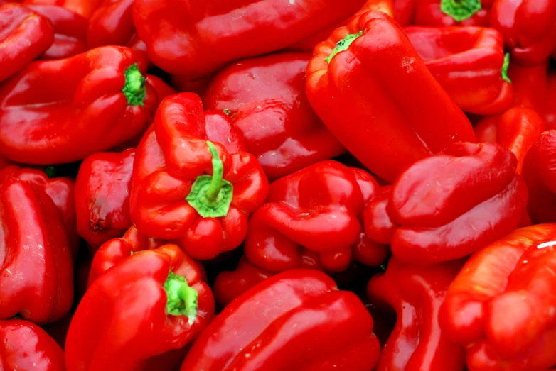 several red peppers together in closeup on display