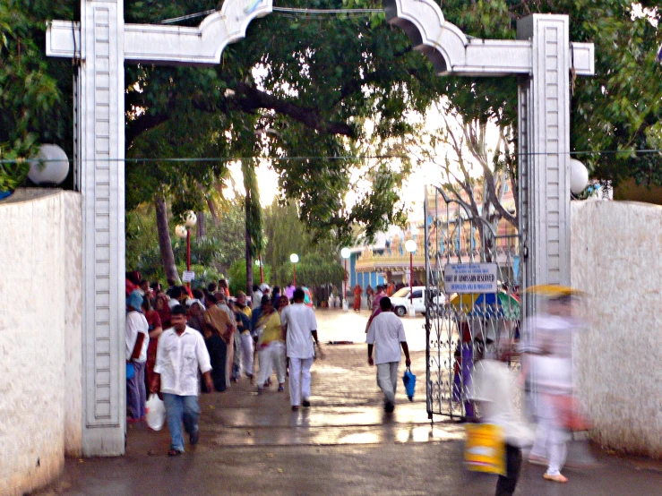 several people are walking under an entrance to a building