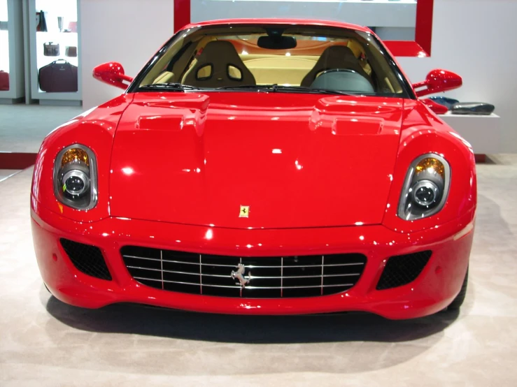 a red sports car on display at a show