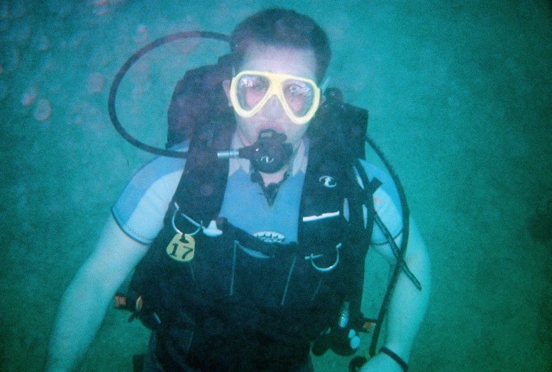 scuba diver with goggles on with scuba equipment