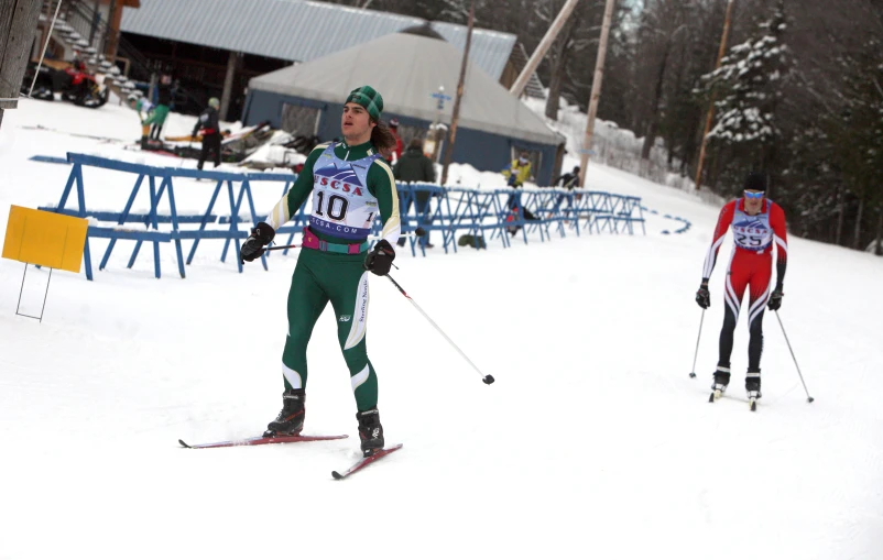 two cross country skiers are racing down the slope