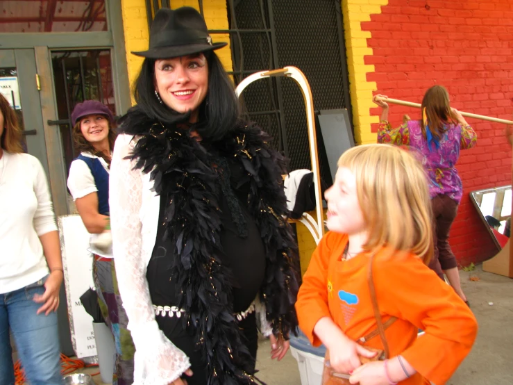 a person with an umbrella and hat standing with a small child