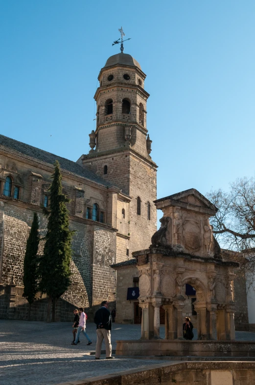 people walk around in front of a church