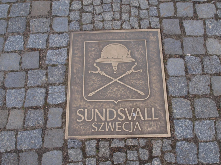 the emblem for the sunset wall is displayed on the sidewalk