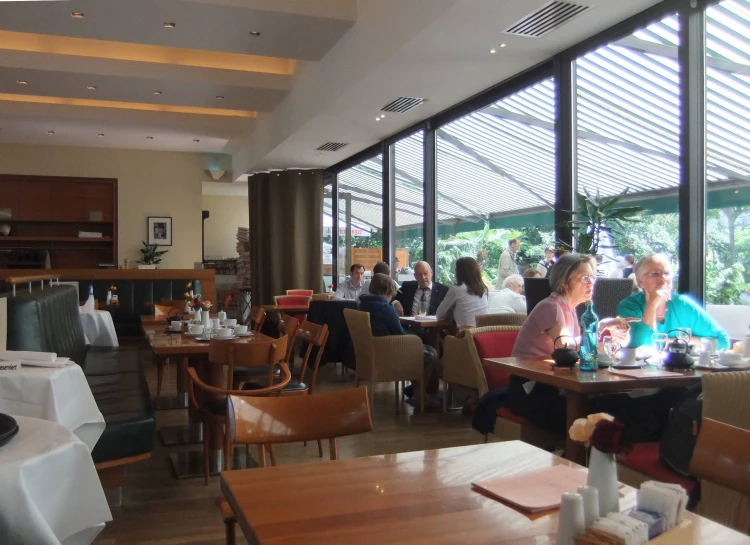 people sitting around in the middle of a restaurant