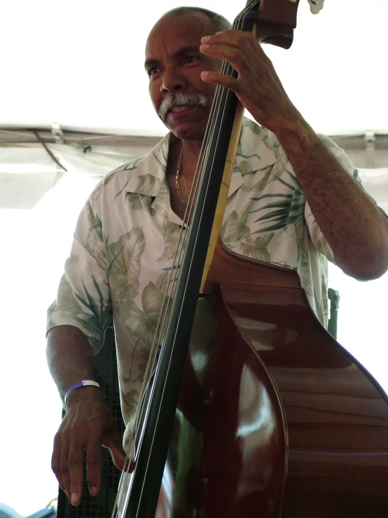 an older man is holding a musical instrument