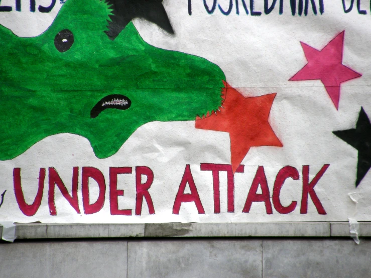 a poster on the wall is written under attack