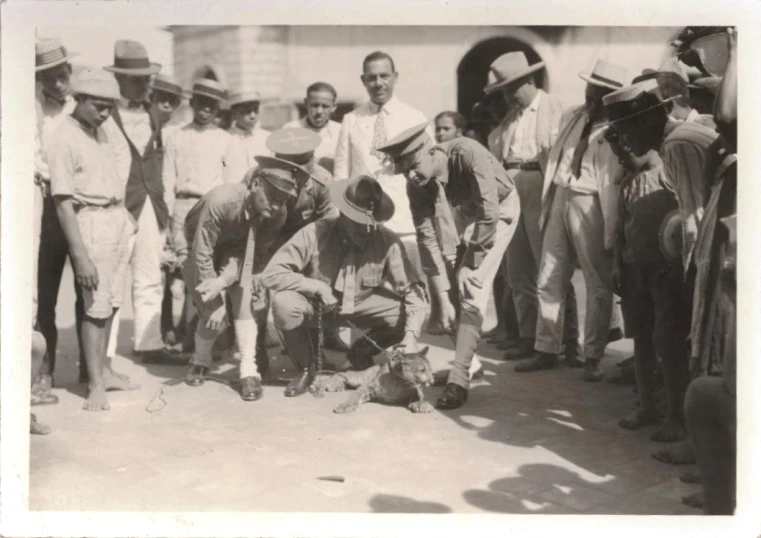 vintage po of men in hats and trench coats by an elephant