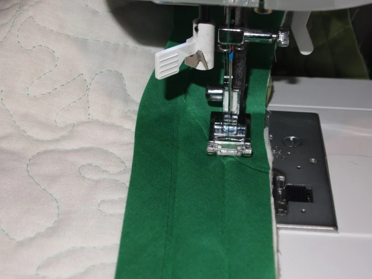 sewing machine and green piece of material behind it