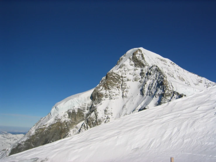 skiers on the side of a mountain in skis