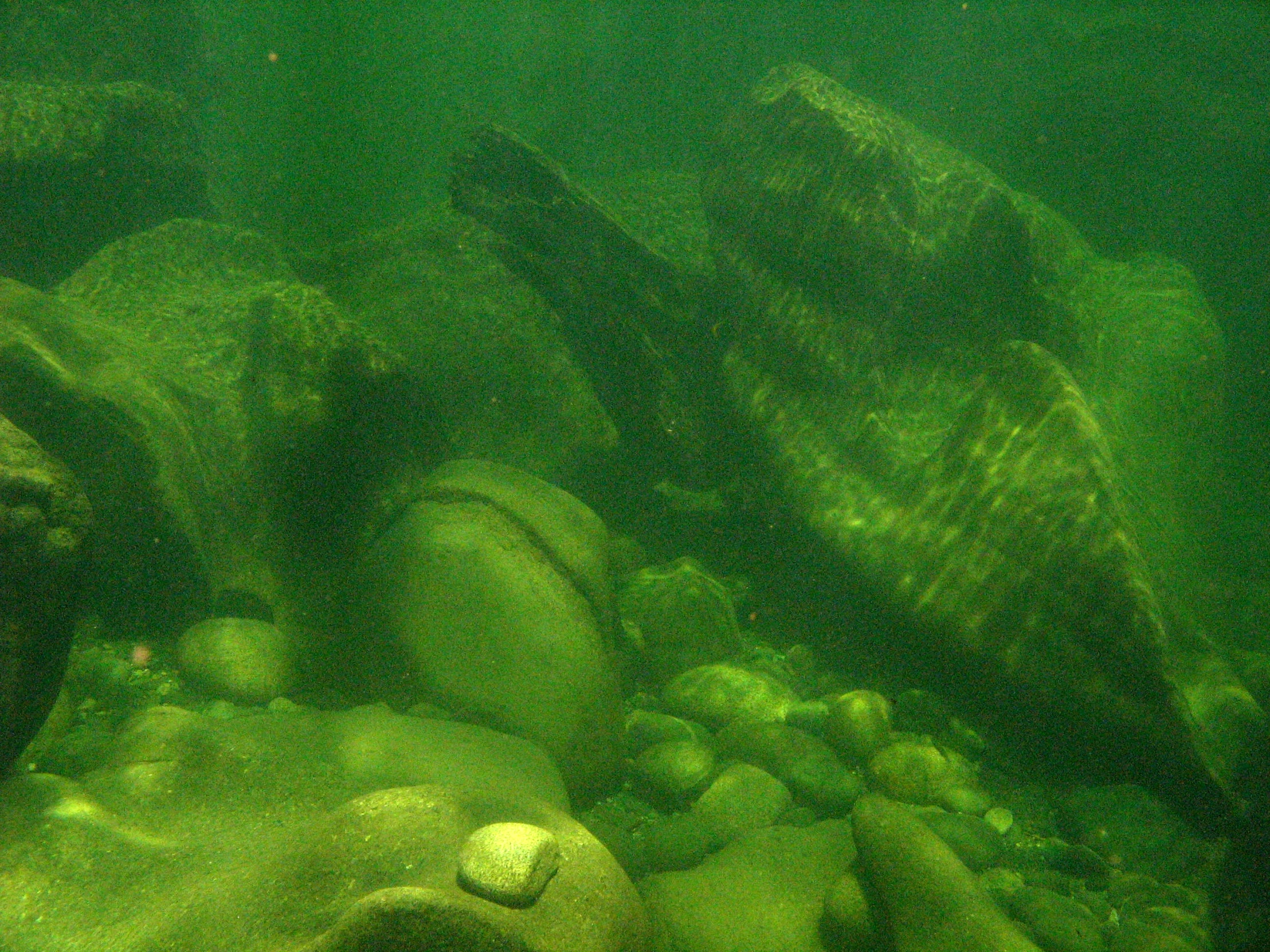 underwater view of several rocks in the water