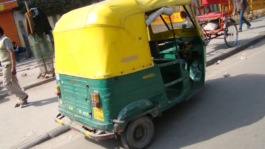 two rickshaws parked on the side of the road