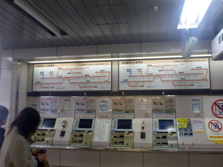 many electronic devices on a wall with signs